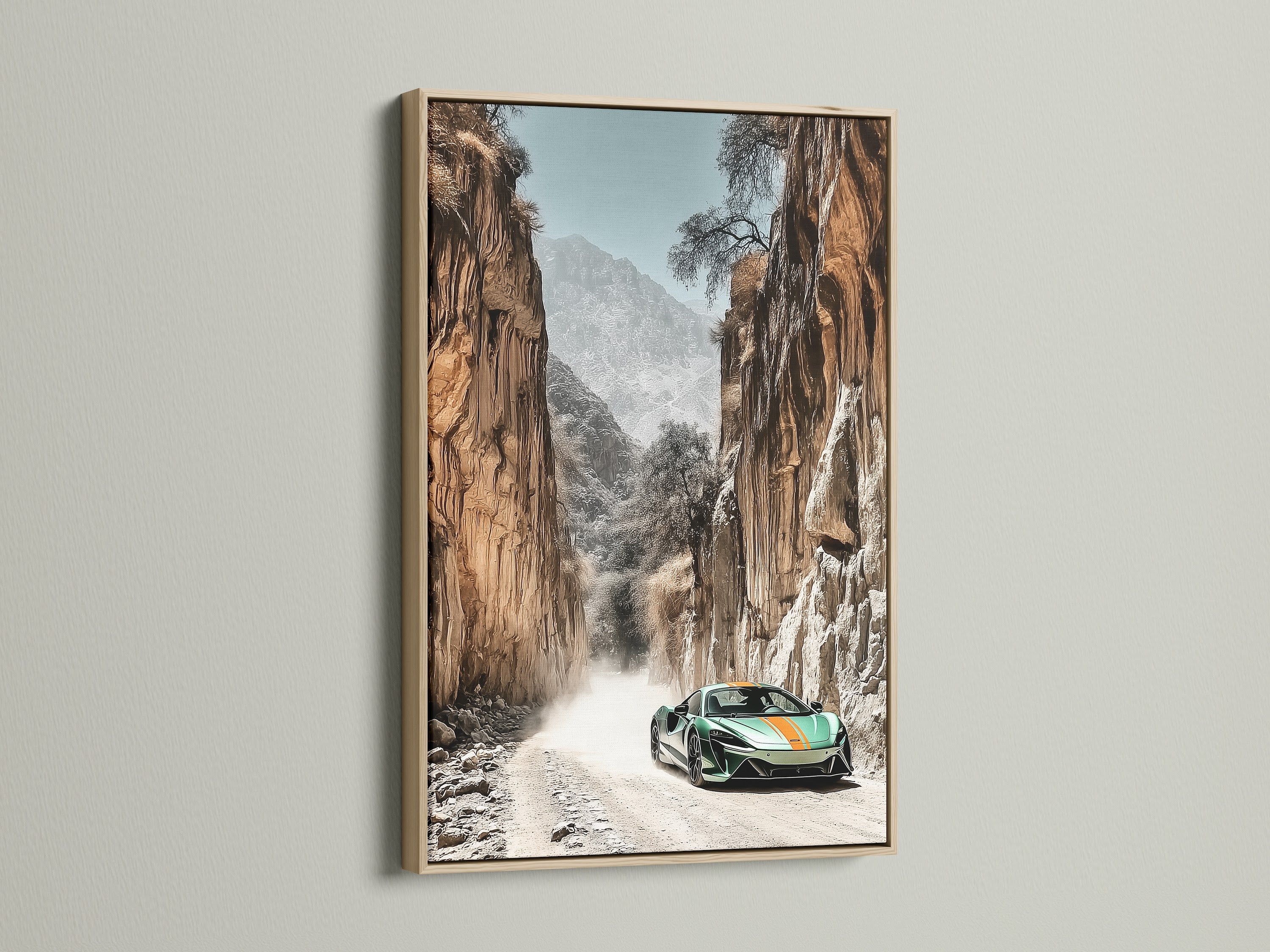 Sports Car Canyon Artwork in an oak frame. This modern automotive art captures a green sports car in a desert landscape. Ideal for car enthusiasts seeking refined wall art. Enhance your garage man cave or living room with this striking piece.
