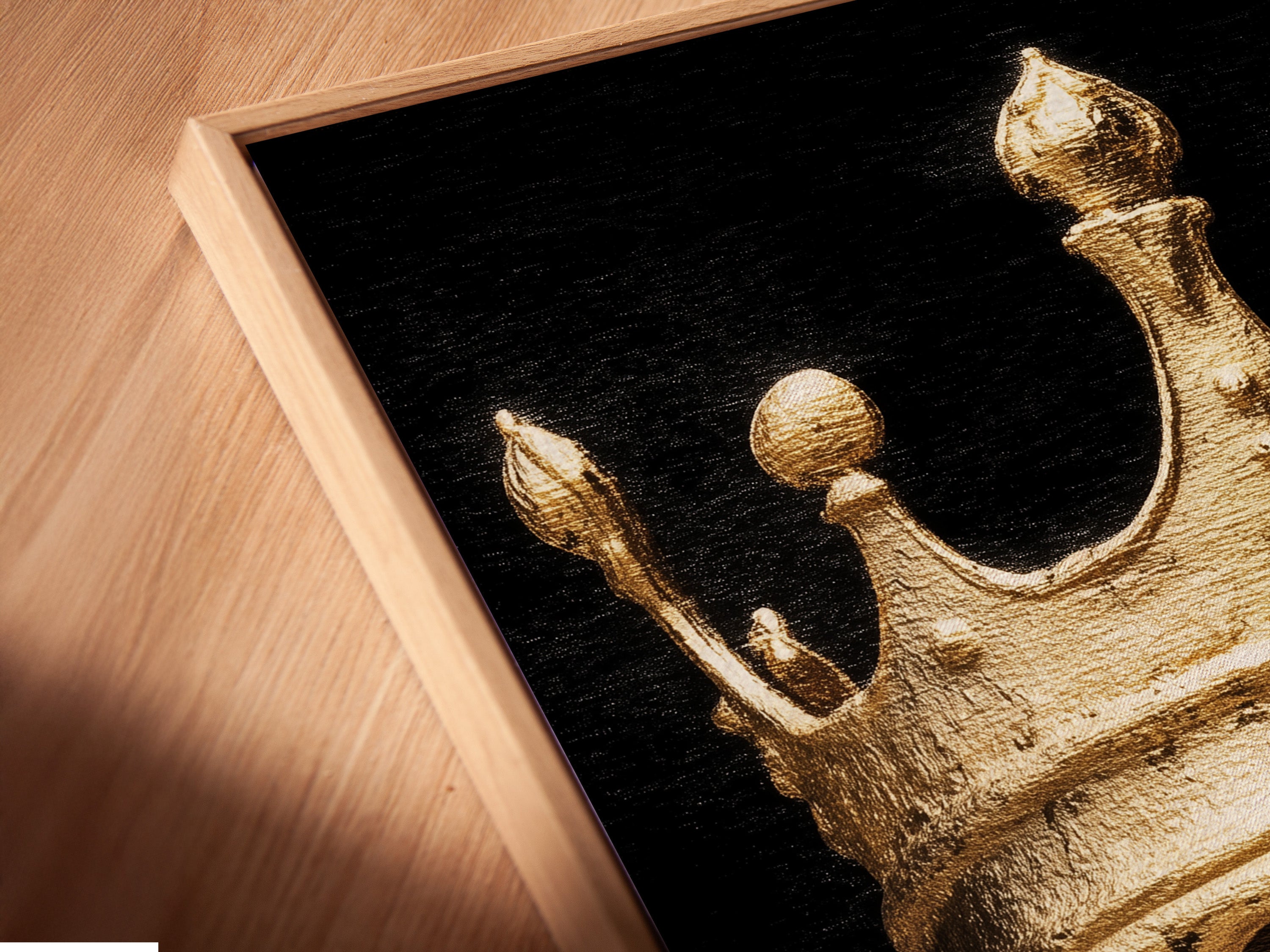 Angled close up of a Melting Crown canvas print in a floating frame. The artwork features a gold melting crown on a black background. The floating frame adds a contemporary touch. Discover gothic home decor.