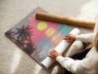 A woman is carefully rolling a fine art poster paper. The paper features a high-quality print of beach art. The scene includes palm trees and a vibrant sunset. Perfect for art enthusiasts and collectors.
