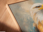 Close-up angled view of a canvas print in a floating frame. This majestic eagle artwork is perfect for home or office. The bird canvas print enhances any space. Ideal patriotic decor with wildlife art. Explore our raptor art and American eagle artwork. Nature wall art at its finest. Shop now and elevate your walls.