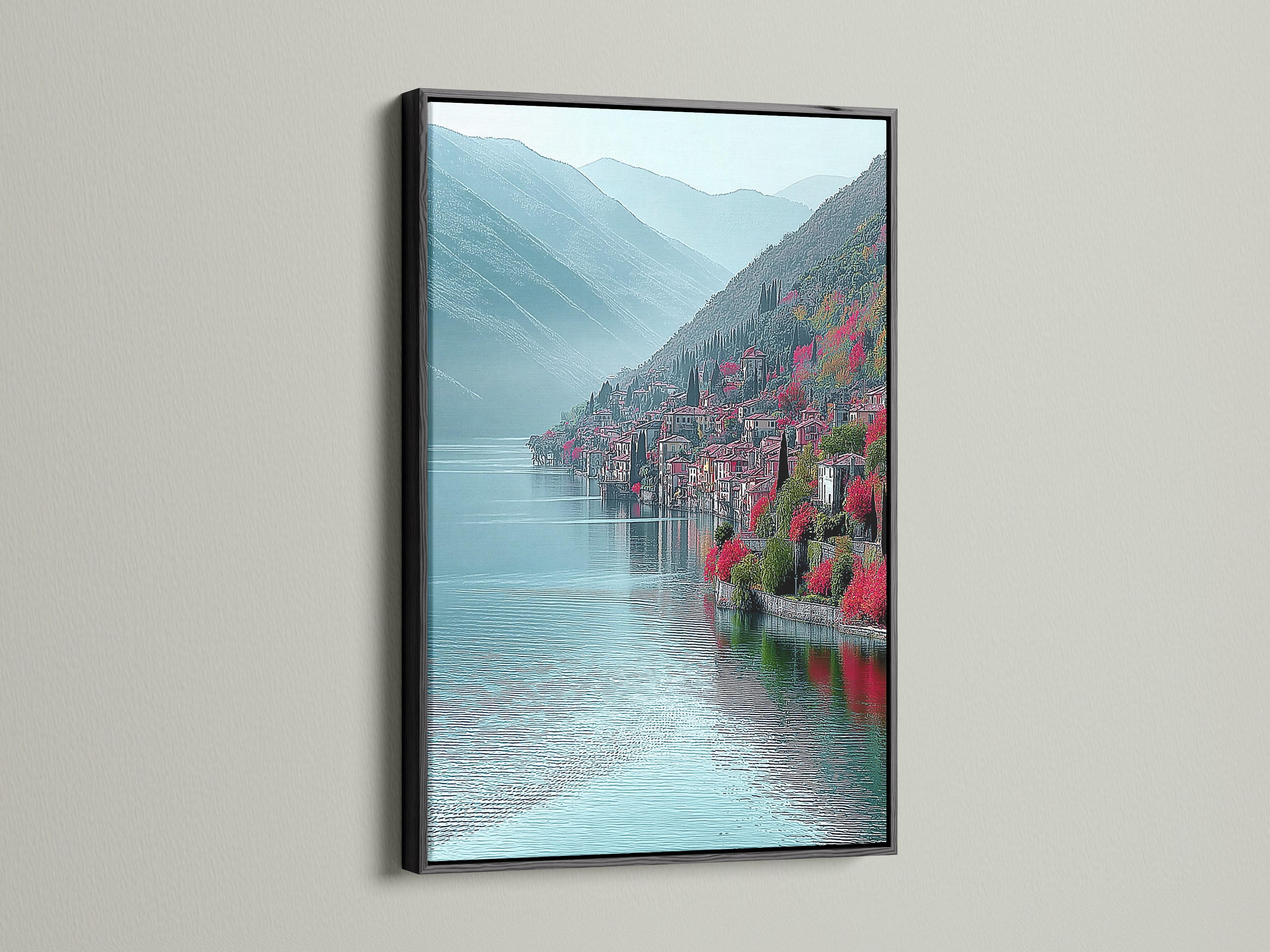 Lake Como Italy canvas artwork with black frame. The black frame accentuates the teal mountain landscape. This Italian coastal wall art is a stunning addition to any room. Perfect for minimalist art lovers. The scenic vista art brings a sense of calm. Consider this for your office wall decor.