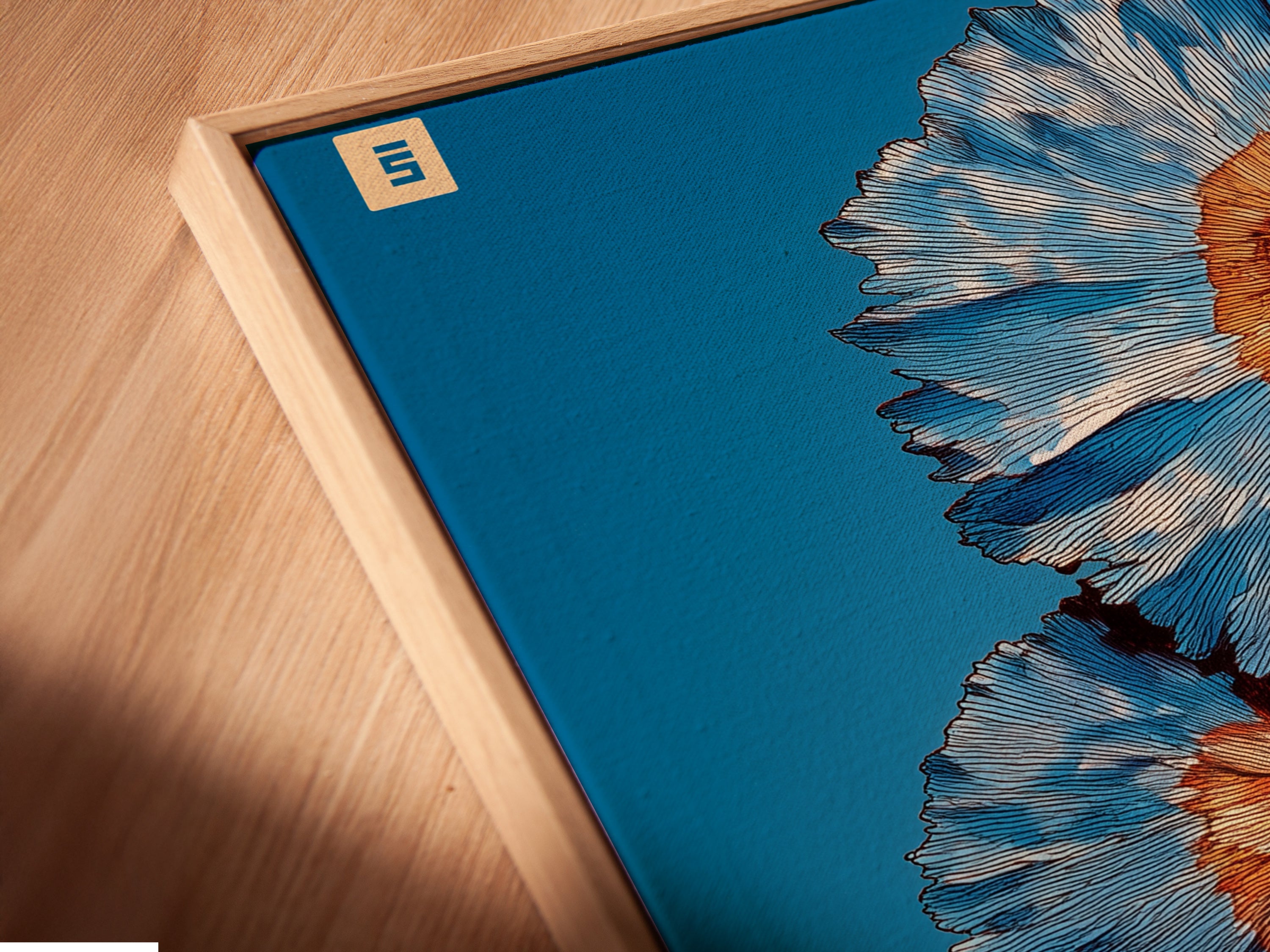 A close-up angled view of a canvas print in a floating frame. The spiral flower artwork features teal and coral tones. It is modern floral art perfect for office wall decor. A beautiful flower canvas with a contemporary feel.