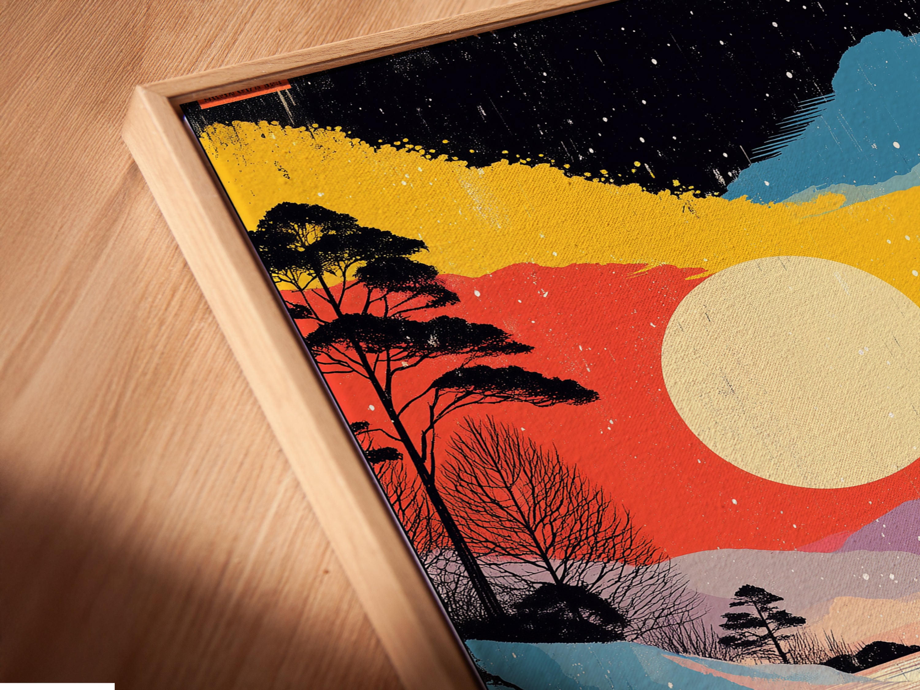 Angled close up of a Winter Sunset Canvas Print in a floating frame. The artwork features a colorful lake landscape. Snowy forest artwork enhances visual appeal. A perfect addition to upscale interiors.