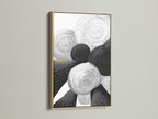 A framed abstract geometric art print. The artwork features black and white circles. The frame is crafted from oak wood. This piece adds a touch of modern minimalist charm to any space. Perfect for living rooms offices or bedrooms.