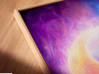 This is a close-up of a canvas print in a floating frame. The Yin Yang cosmic energy wall art is visible. The spiritual purple and blue abstract art is on display. It is perfect for adding zen to your space. Explore cosmic energy prints and chakra wall art