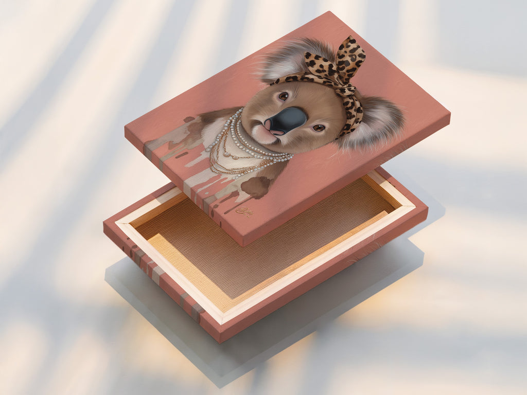Stretched canvas print displays the Koala Wall Art. This trendy animal print is perfect for nurseries. The Koala wears a leopard print headband and pearl necklace. This stretched canvas adds a modern touch.