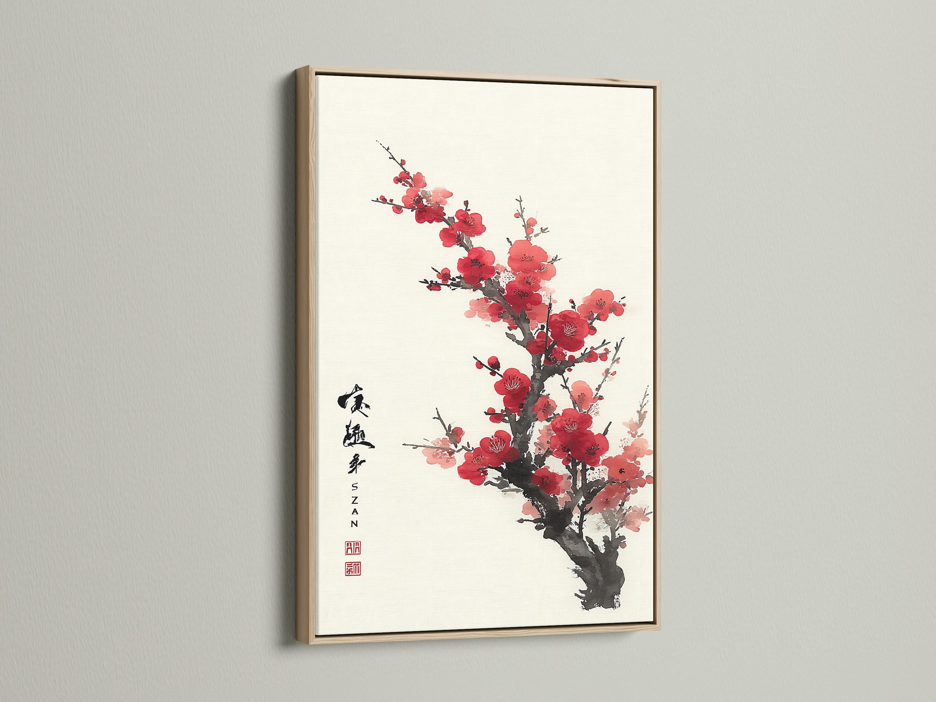 Artwork featuring red blossoms in an oak frame. The frame complements the art beautifully. The art is hung on a white wall. Add a touch of nature to your home decor. Discover the beauty of framed artwork. Bring life and color to your walls.
