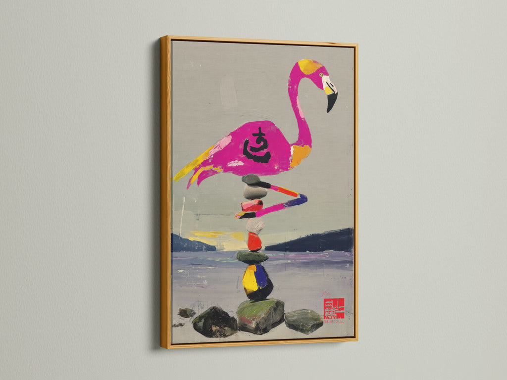 A gold frame enhances this flamingo and zen stone stack artwork. The art piece features a colorful bird balancing stones. The gold frame adds a touch of elegance. It makes it a perfect addition to a spa or sunroom. 