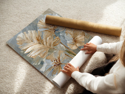 A woman is carefully rolling a fine art poster paper print. The artwork is a beige and blue neutral floral. The art is modern botanical. It would look great in minimalist Scandinavian or contemporary spaces. This art is perfect for an office.