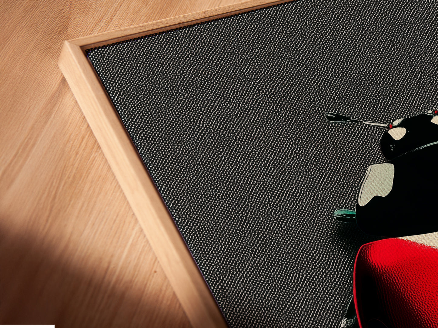 Close up of a canvas print in a floating frame. The ladybug art looks stunning with this modern framing option. The red beetle and black spots are vivid and eye catching. Ideal for kids rooms dorms or contemporary spaces.