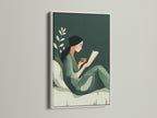 The Reading Woman art print is showcased in a white frame. This minimalist wall art adds a fresh clean look to your decor. The sage green botanical print complements various styles. It's great for creating a cozy reading nook or study room.