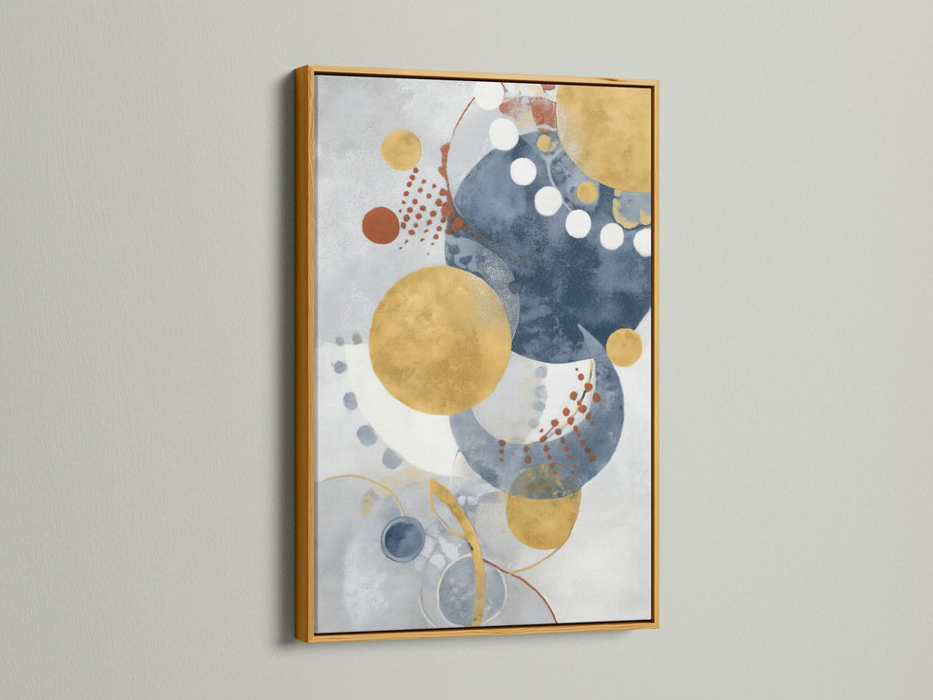 Modern geometric wall art in a gold frame brings elegance to your decor. The abstract artwork features blue and gold circles. This contemporary watercolor print is perfect for any room.