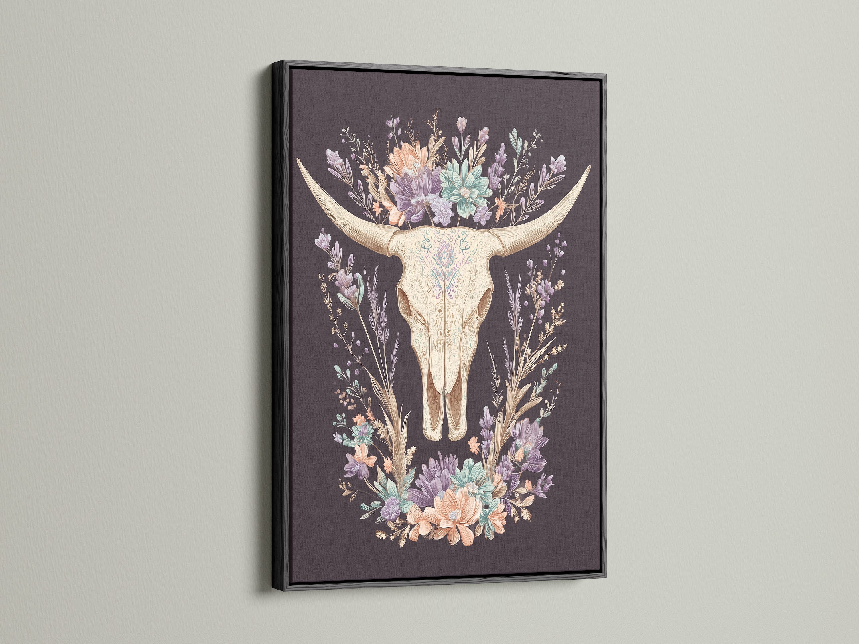 Artwork featuring a bovine skull with floral elements. It is encased in a black frame. The black frame provides a bold and contemporary look. The artwork makes a statement on any wall. A striking contrast is created with lighter backgrounds. This art piece adds drama to your space.