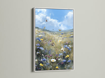 Wildflower Meadow canvas art in a white frame. The artwork features a butterfly field wall art. This art brings a blue sky landscape painting to bedroom decor. It is a simple and elegant style.