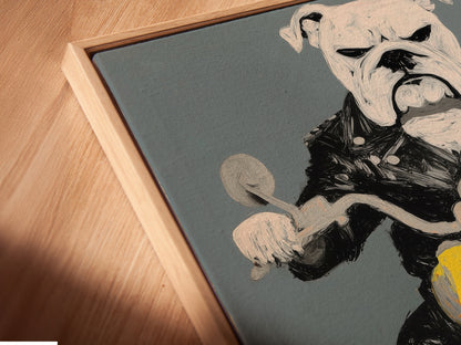 A close-up angled view of the Bulldog Biker canvas print in a floating frame. The floating frame enhances the artwork's visual appeal. Perfect as biker wall decor or motorcycle decor for any room.