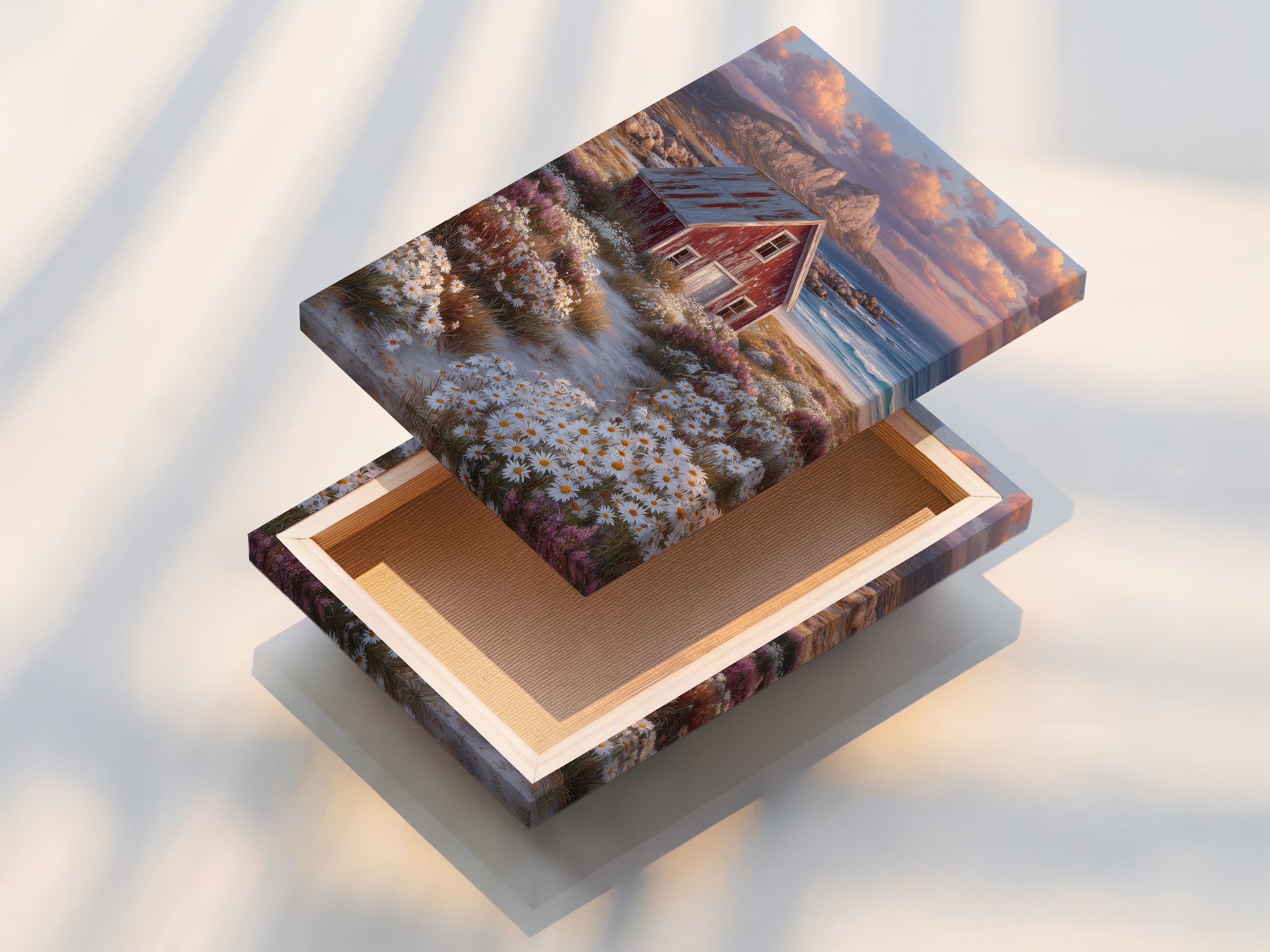 A stretched canvas print featuring coastal cottage art. The artwork showcases a rustic red barn and wildflower art. This piece enhances farmhouse decor. It brings a touch of the coast to your home.