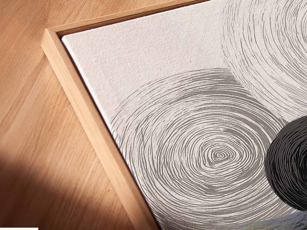 A close-up of a canvas print. The abstract geometric art features black and white circles. It is set in a floating frame. The angled view highlights the texture and depth. This is ideal for modern minimalist spaces adding a touch of elegance.