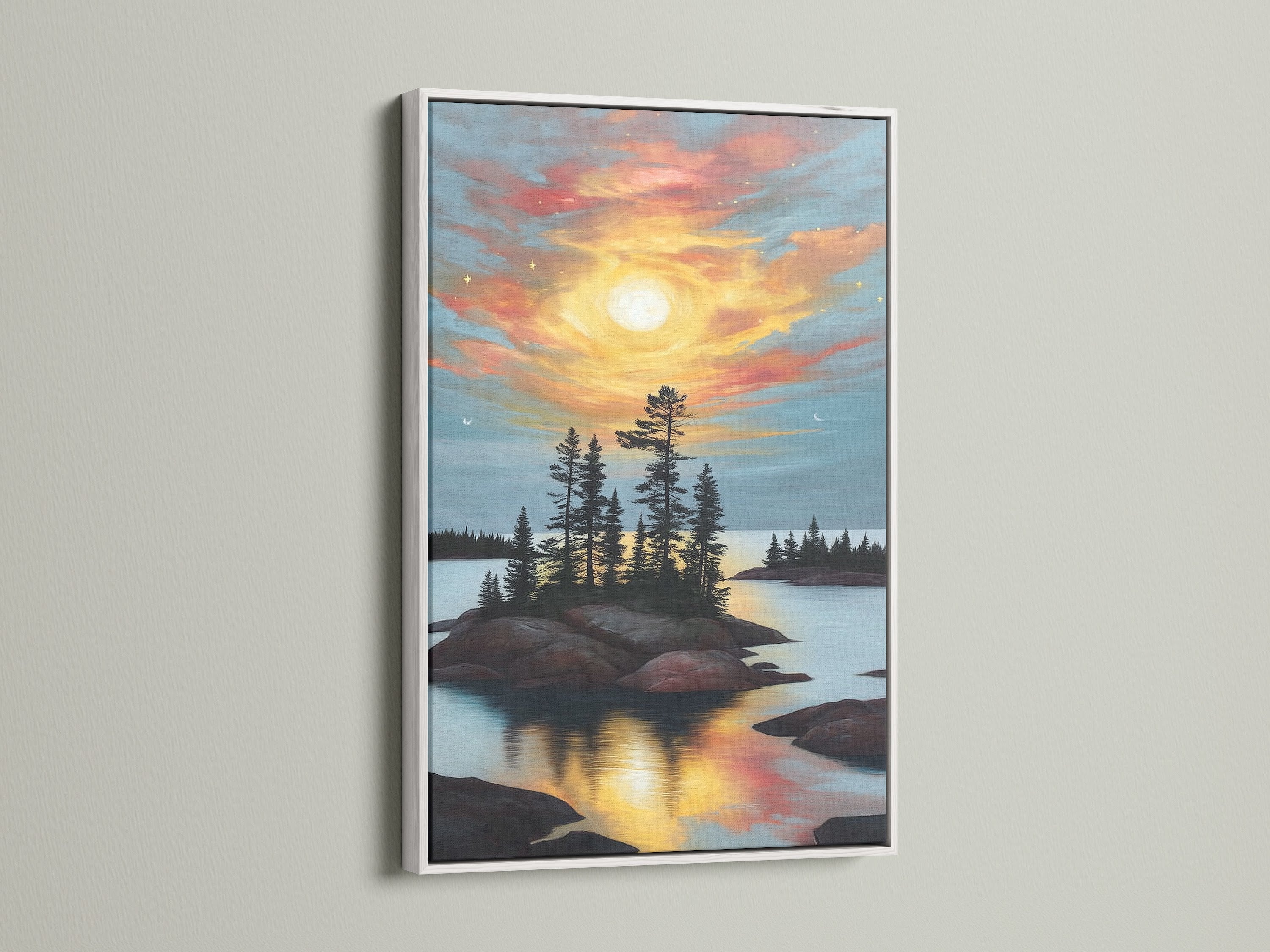 Lake Sunset Canvas Print is showcased in a white frame. The serene nature artwork captures the beauty of a sunset over a lake with pine trees. Enhance your living room or bedroom with this elegant piece. It will fit rustic styles.