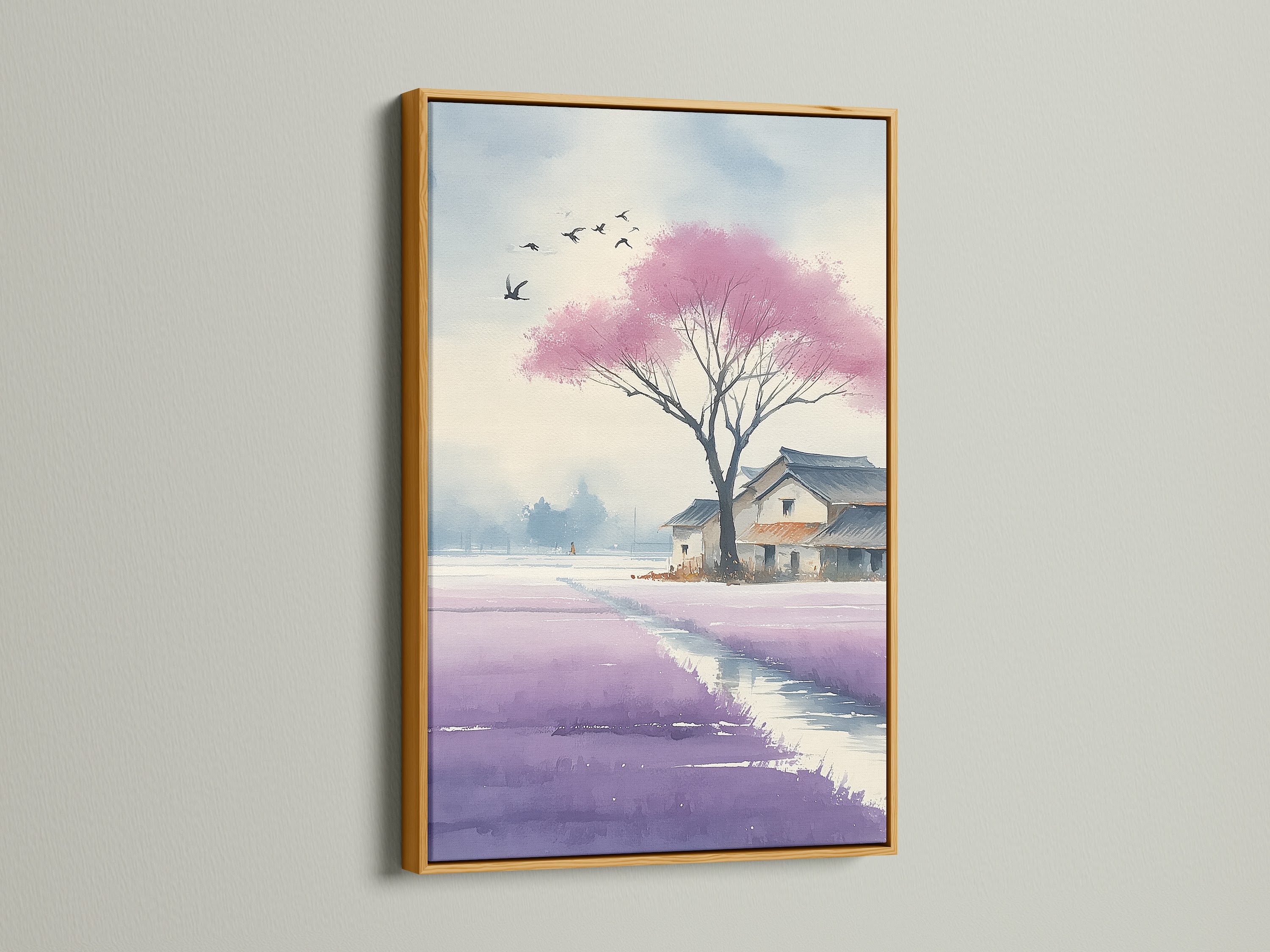 A Gold framed Japanese Cherry Blossom artwork is displayed. The watercolor canvas art captures a violet lavender field. Ideal as office wall decor or for creating a calming zen atmosphere. This Asian landscape artwork complements contemporary styles.