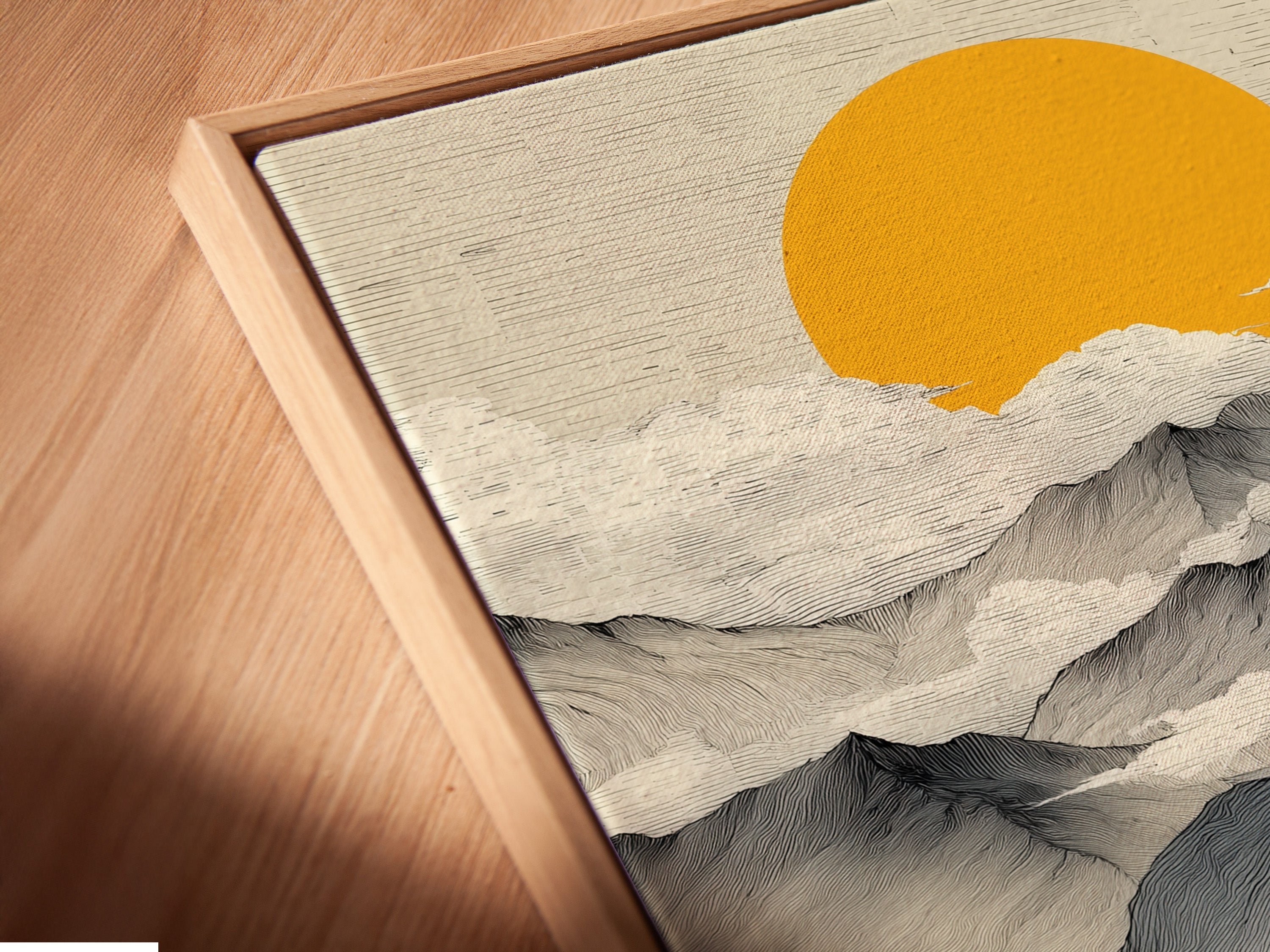 A close-up angled view reveals the canvas print in a floating frame. The abstract landscape artwork appears to hover. See the fine details of the golden sun nature poster. A modern way to display mountain wall art. The floating frame enhances the artwork's minimalist appeal. A contemporary choice for any space.