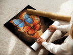 A woman is carefully rolling a fine art poster paper featuring the butterfly artwork. The insect print showcases vibrant blue and orange colors. This nature-inspired print is ready for framing or display. Ideal for art enthusiasts.