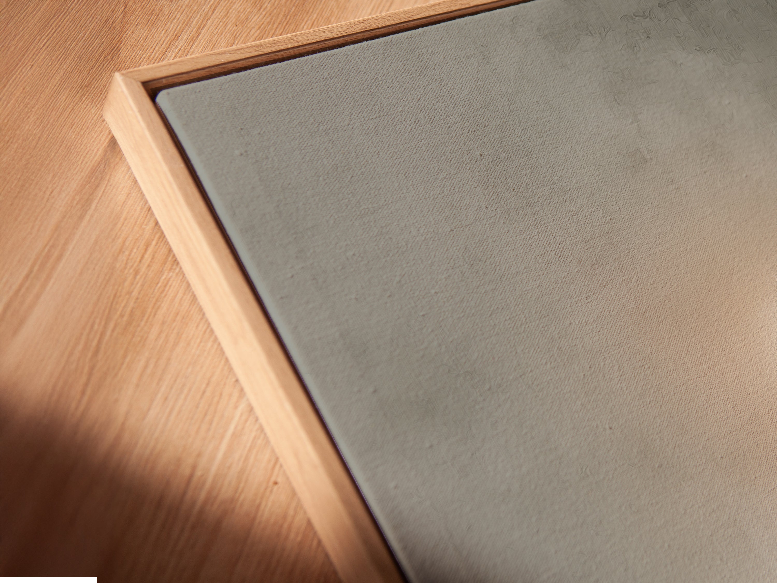 Angled close up of a canvas print in a floating frame. This art is of a woman reading by candlelight. The floating frame gives a modern touch. This gothic wall art will enhance any room.