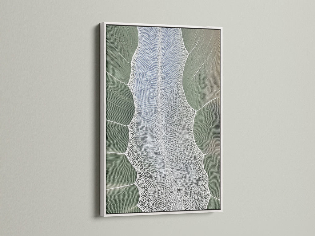 A white frame displays abstract tree artwork. The artwork features sage green nature elements. The art is a canvas print for bedroom decor. The style is contemporary. The secondary color is white.