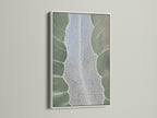 A white frame displays abstract tree artwork. The artwork features sage green nature elements. The art is a canvas print for bedroom decor. The style is contemporary. The secondary color is white.
