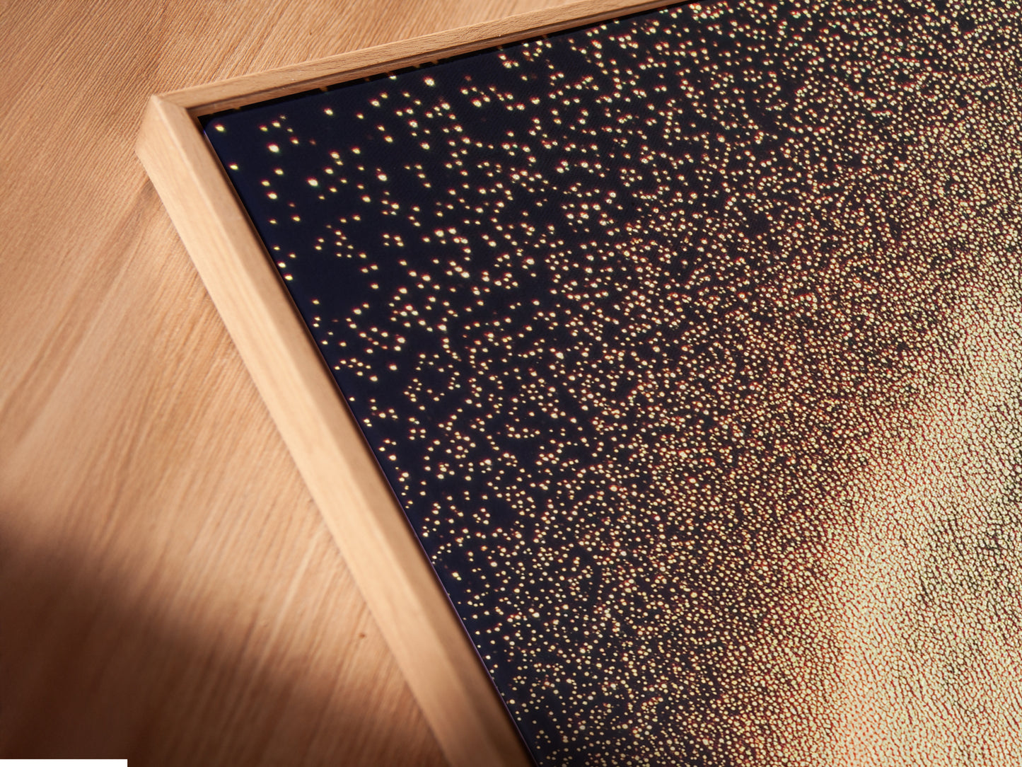 Close-up of a celestial canvas print in a floating frame. The abstract family artwork adds a modern touch to any room. The cosmic sparkle poster is perfect for kids room wall decor. This dreamy wall art enhances studios lobbies and clinics. Elevate your space with this elegant framed artwork.