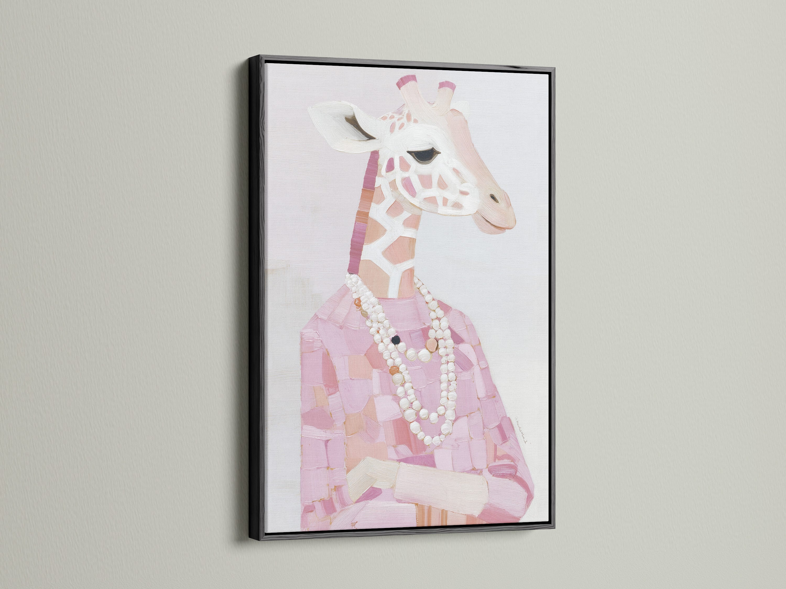 A black frame presents a Giraffe Portrait Canvas Print. The pink animal print creates a chic look. Fashion giraffe art is perfectly framed with a pearl necklace. Black frame contrasts beautifully with blush pink art. This stylish animal art is striking.