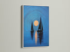 A white frame enhances this coastal artwork. The framed print shows navy blue sailboats and a sunset. It is great for bedroom wall decor or living room art. The nautical art print is a stylish choice. It complements minimalist Scandinavian or coastal styles. 