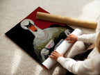 A woman is carefully rolling a fine art poster paper featuring the Swan Tea Party artwork. This whimsical animal art is perfect for adding a unique touch to your home decor. Get your own fine art poster today.