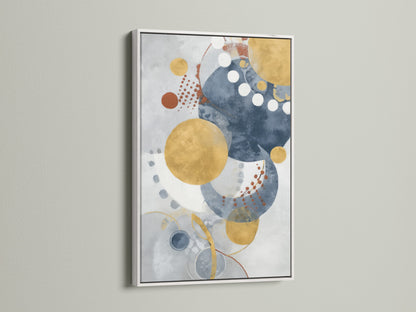 Modern geometric wall art in a white frame creates a clean look. The abstract artwork features blue and gold circles. Ideal contemporary watercolor print for bedroom wall decor.