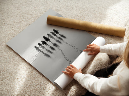 A woman carefully rolls a fine art poster paper of the Beach Walk print. This black and white seascape photography is ready for framing. Ideal for nursery wall decor or coastal artwork. A minimalist art choice for family photos.