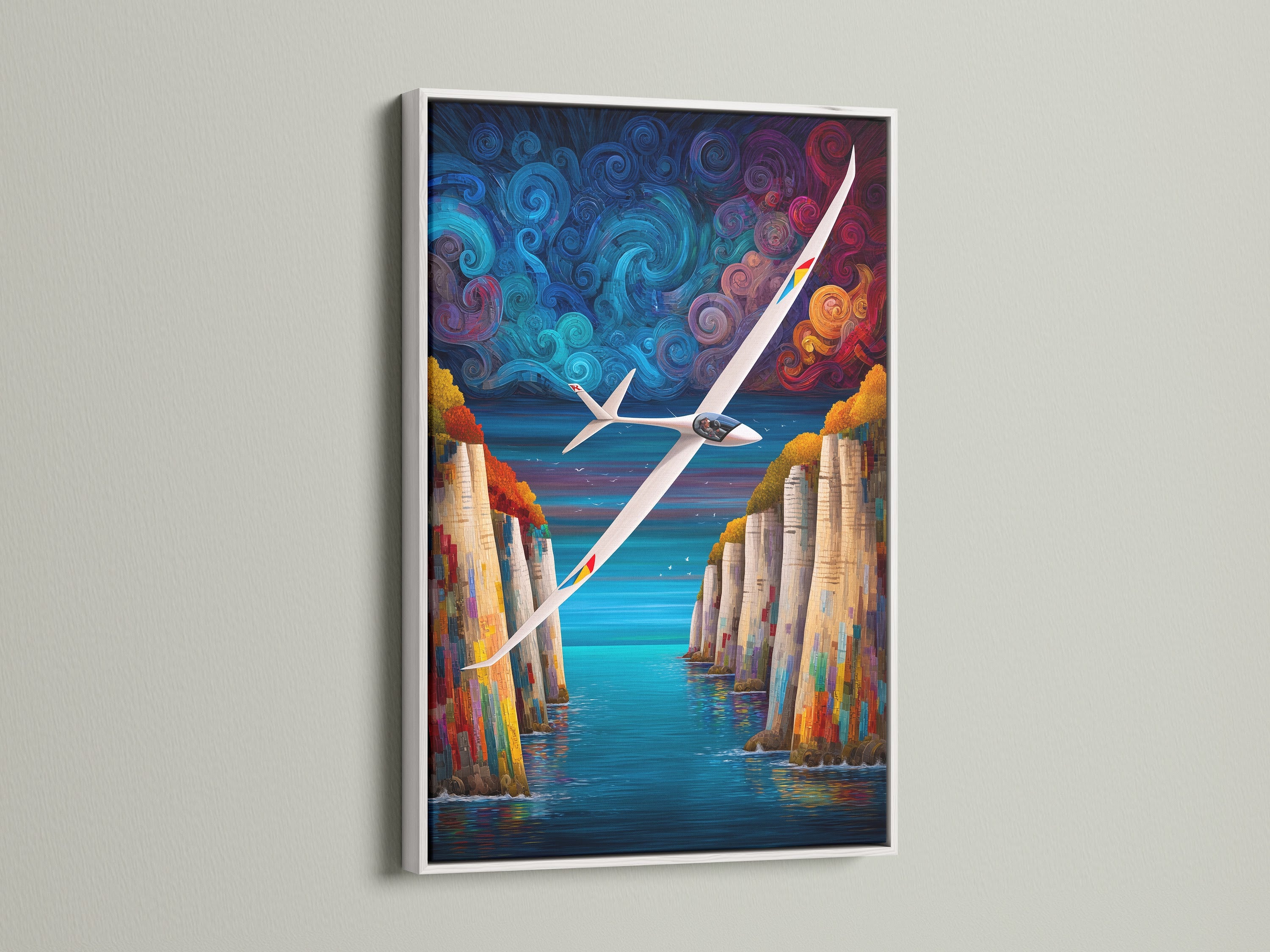 Sailplane artwork with a white frame. This aviation canvas features a vibrant cliff landscape. The colorful artwork enhances any space. Consider it for aviation enthusiasts or as office decor