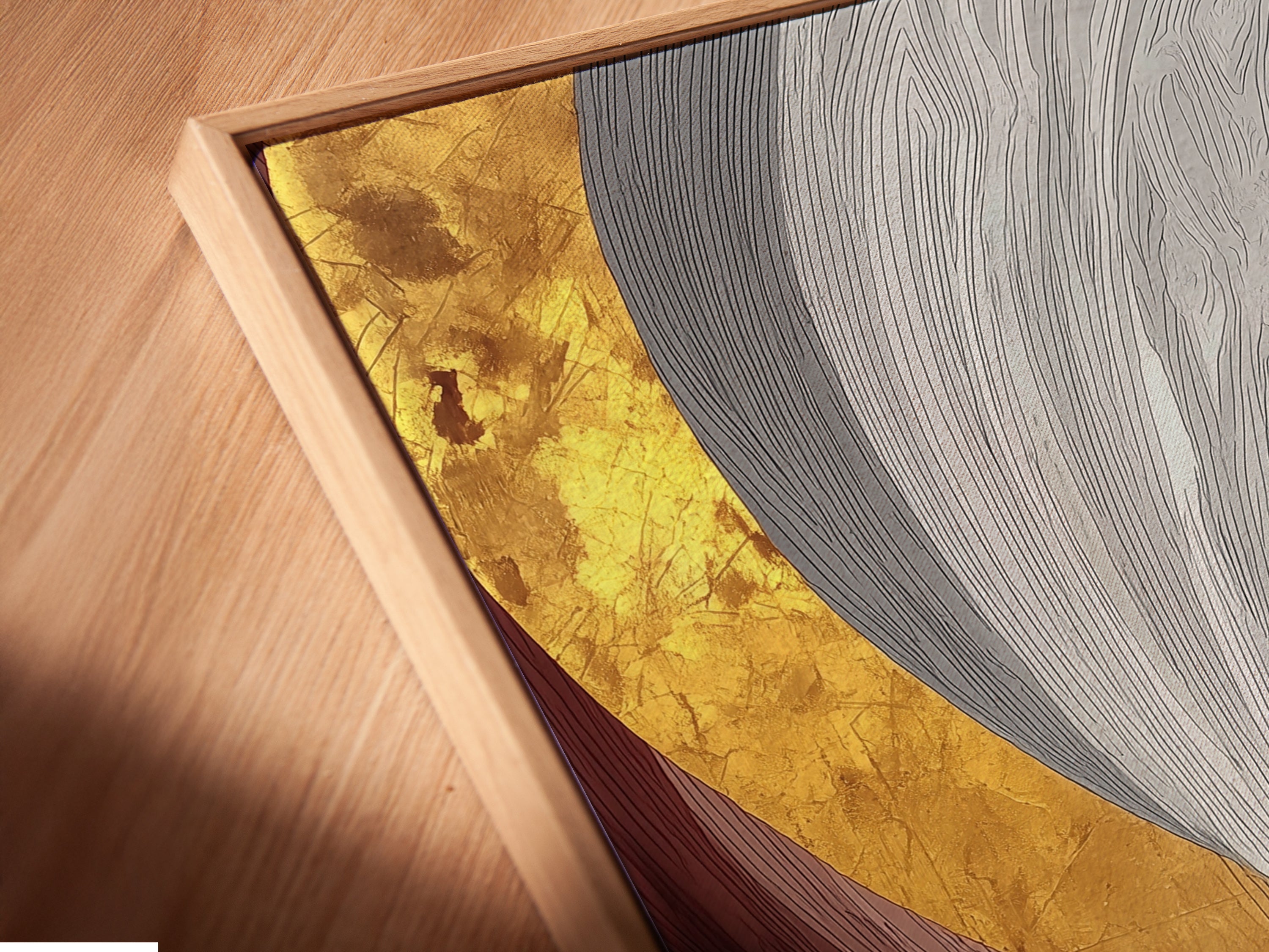 A close-up angled view of a canvas print in a floating frame. This modern artwork features cyclists in silhouette against an abstract gold and gray background. The floating frame adds a stylish touch.