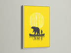 Bear Canoe artwork framed in a white frame. The yellow art print features a bear and man in a canoe. A white frame is a great option for any room. This artwork is ideal for cabin art or woodland decor.