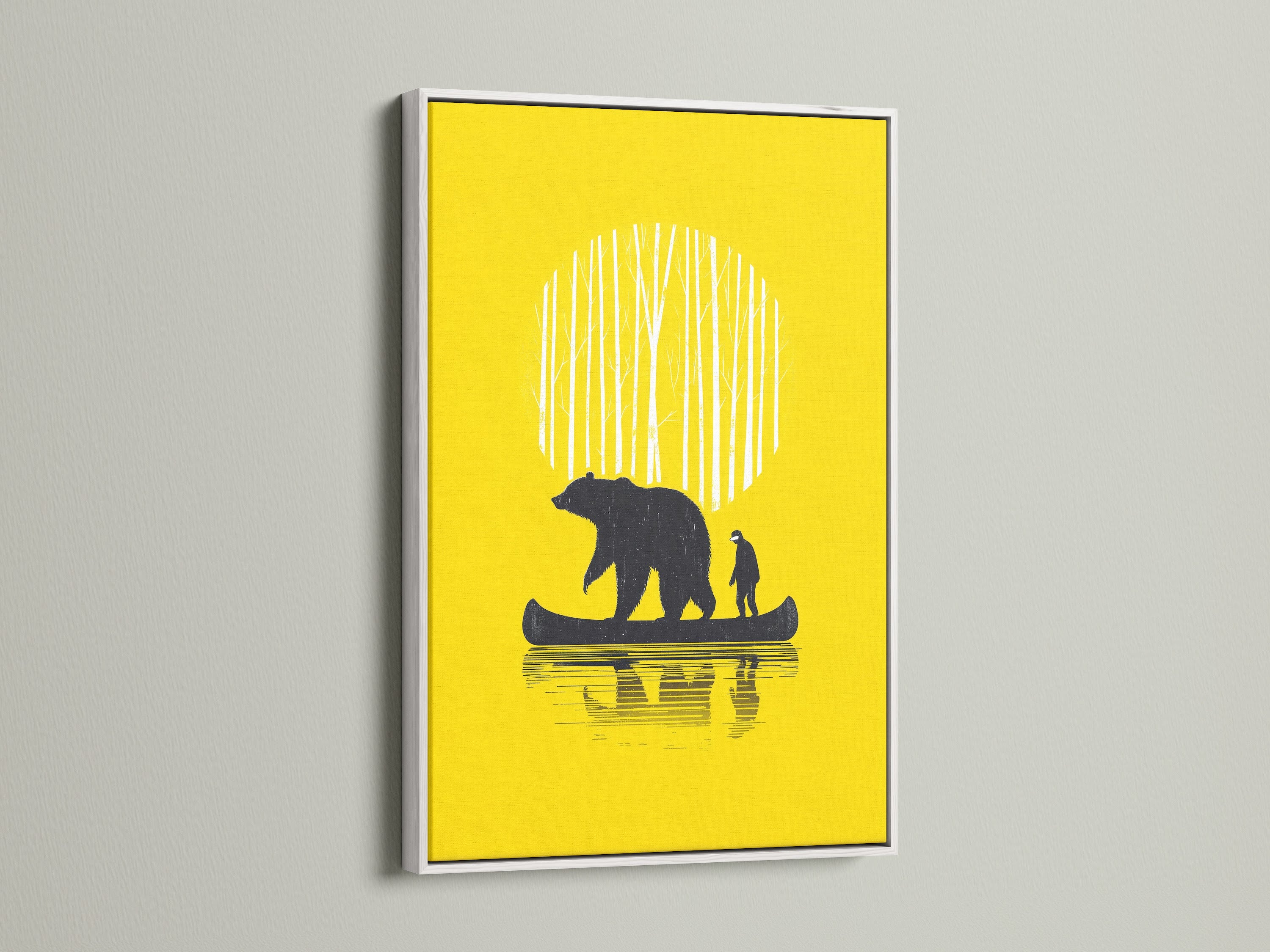 Bear Canoe artwork framed in a white frame. The yellow art print features a bear and man in a canoe. A white frame is a great option for any room. This artwork is ideal for cabin art or woodland decor.