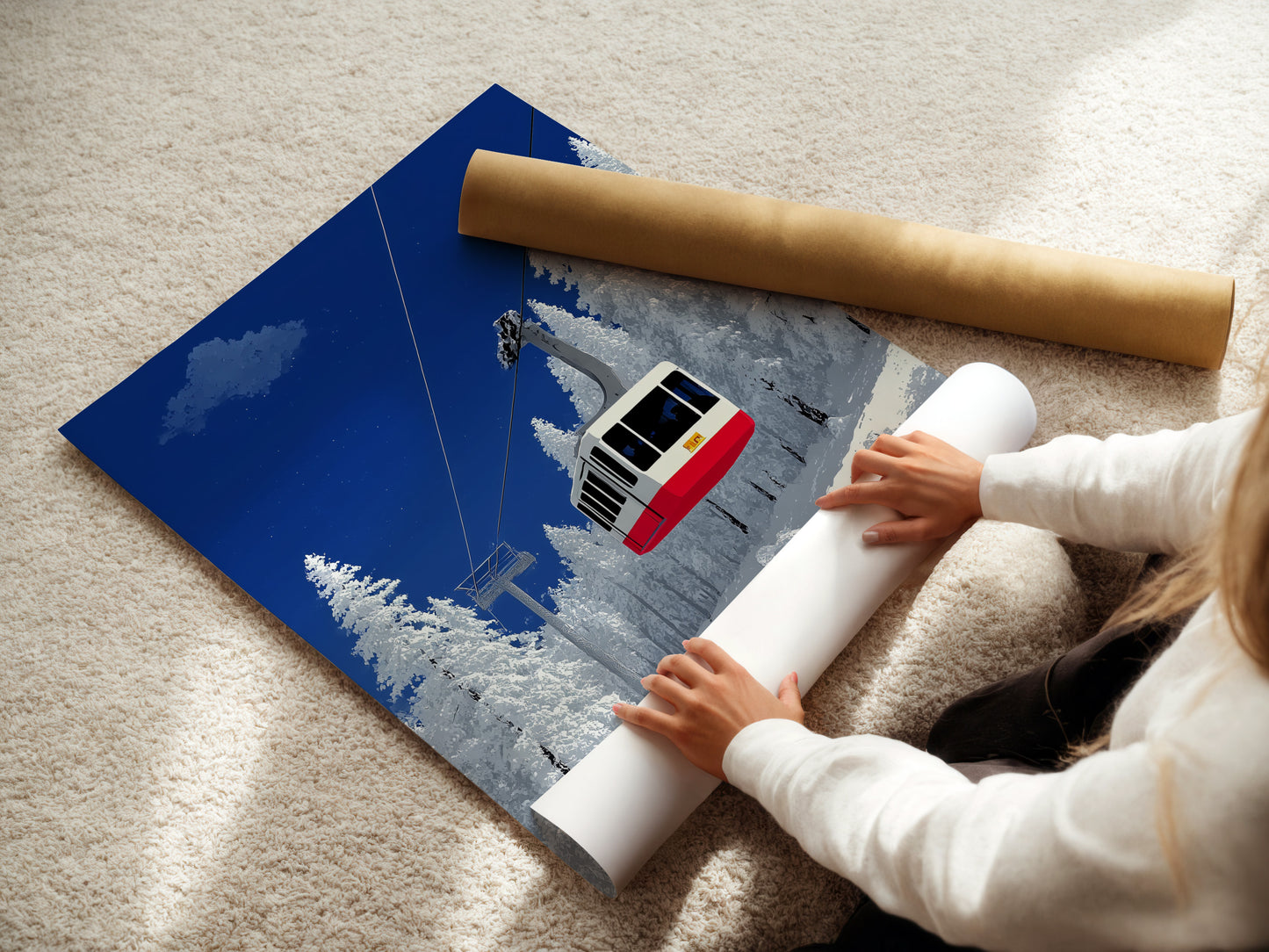 A woman is carefully rolling a fine art poster paper. This paper features a ski lift artwork. The winter mountain wall art is ideal for cabin decor. The alpine cable car print is perfect for a snowy landscape. This poster paper allows for custom framing. It provides a versatile option for art lovers.