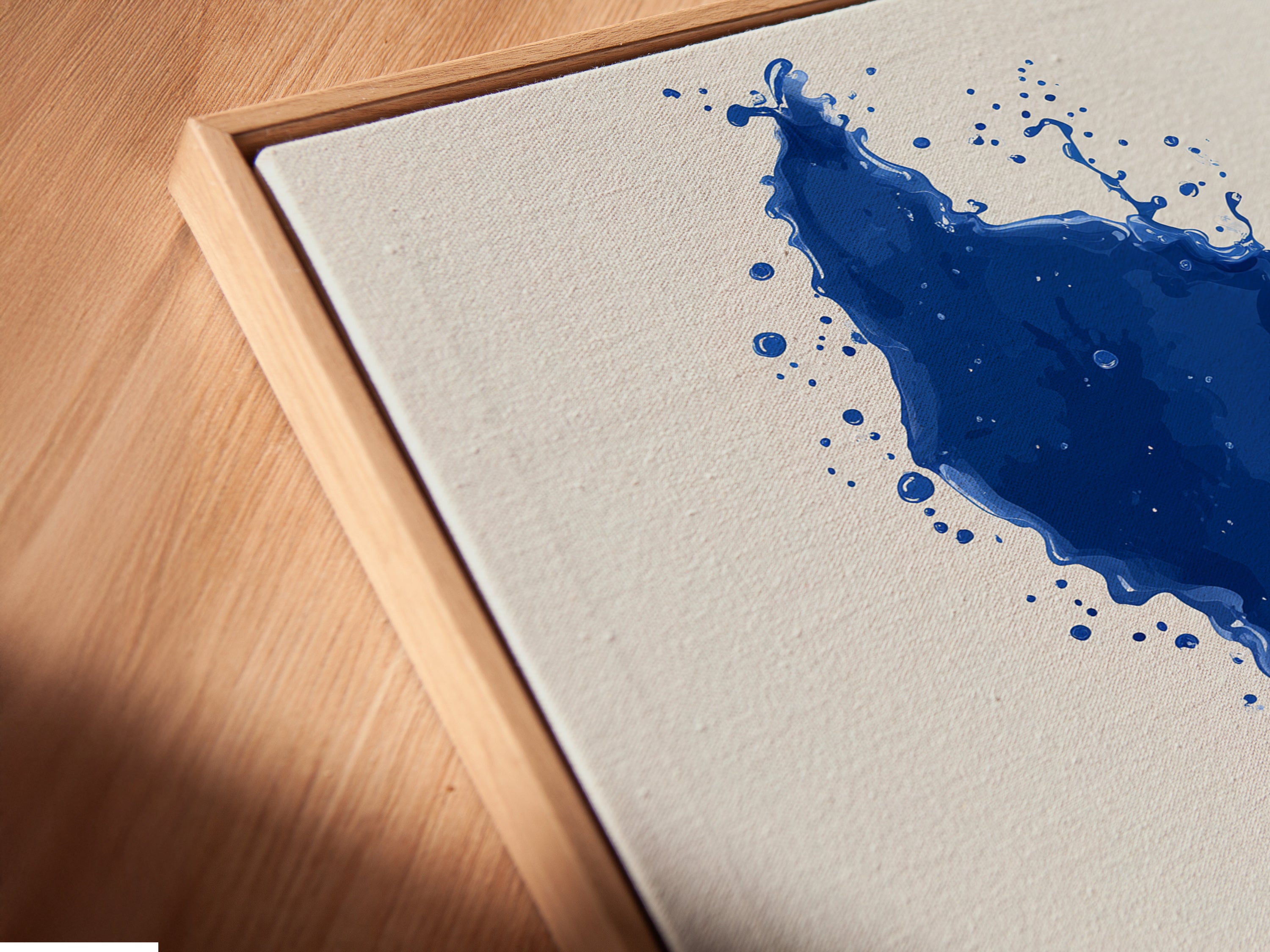 A detailed close-up of a canvas print. The cobalt blue whale tail artwork is in a floating frame. The frame enhances the artwork's contemporary feel. It is perfect for coastal or nautical themed spaces.