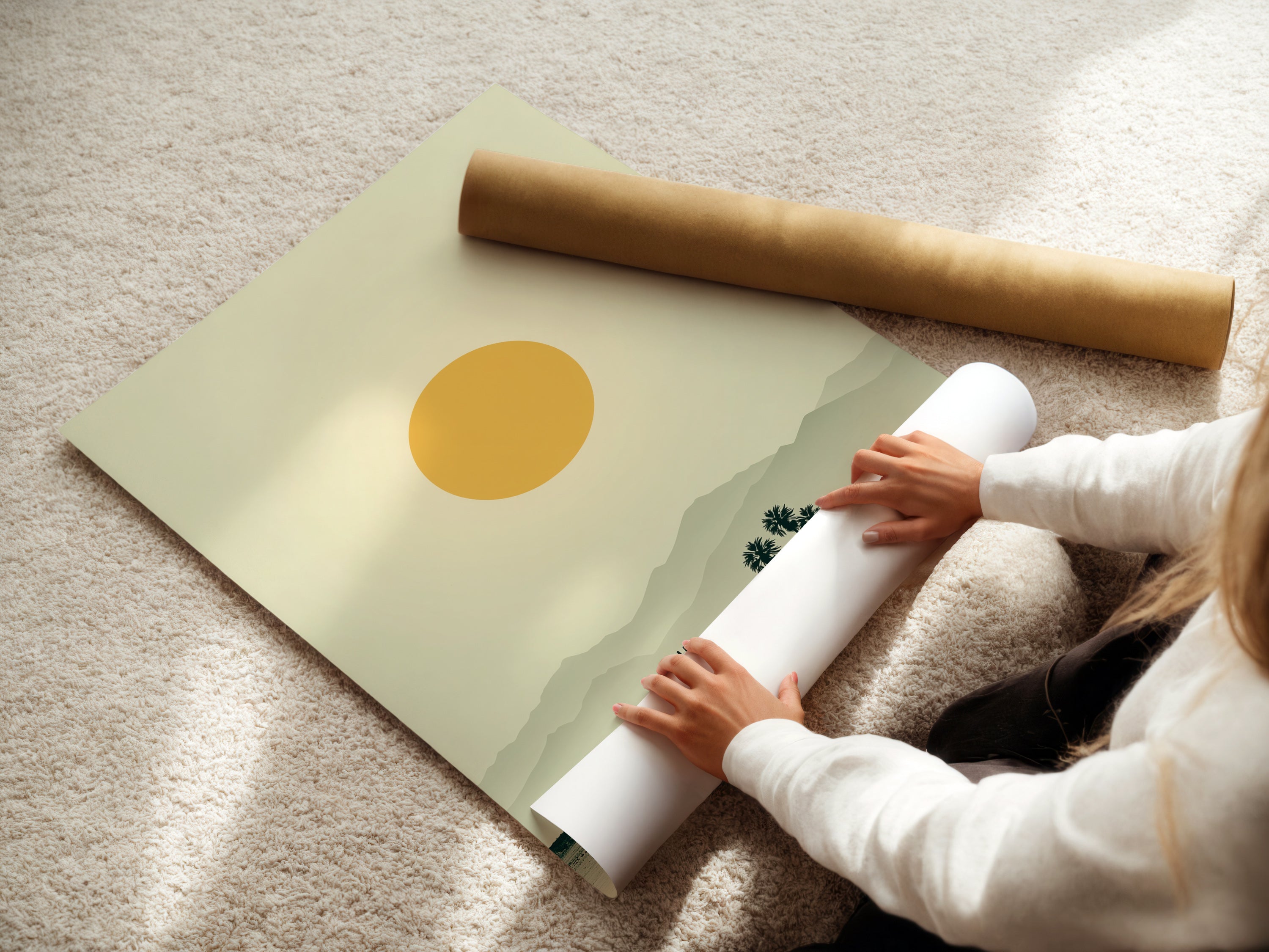 A woman is carefully rolling a fine art poster paper. This ensures safe handling of the desert landscape artwork. The artwork features warm earth tones. It is minimalist art. This print brings southwestern decor to a home or office. It creates a calming atmosphere.