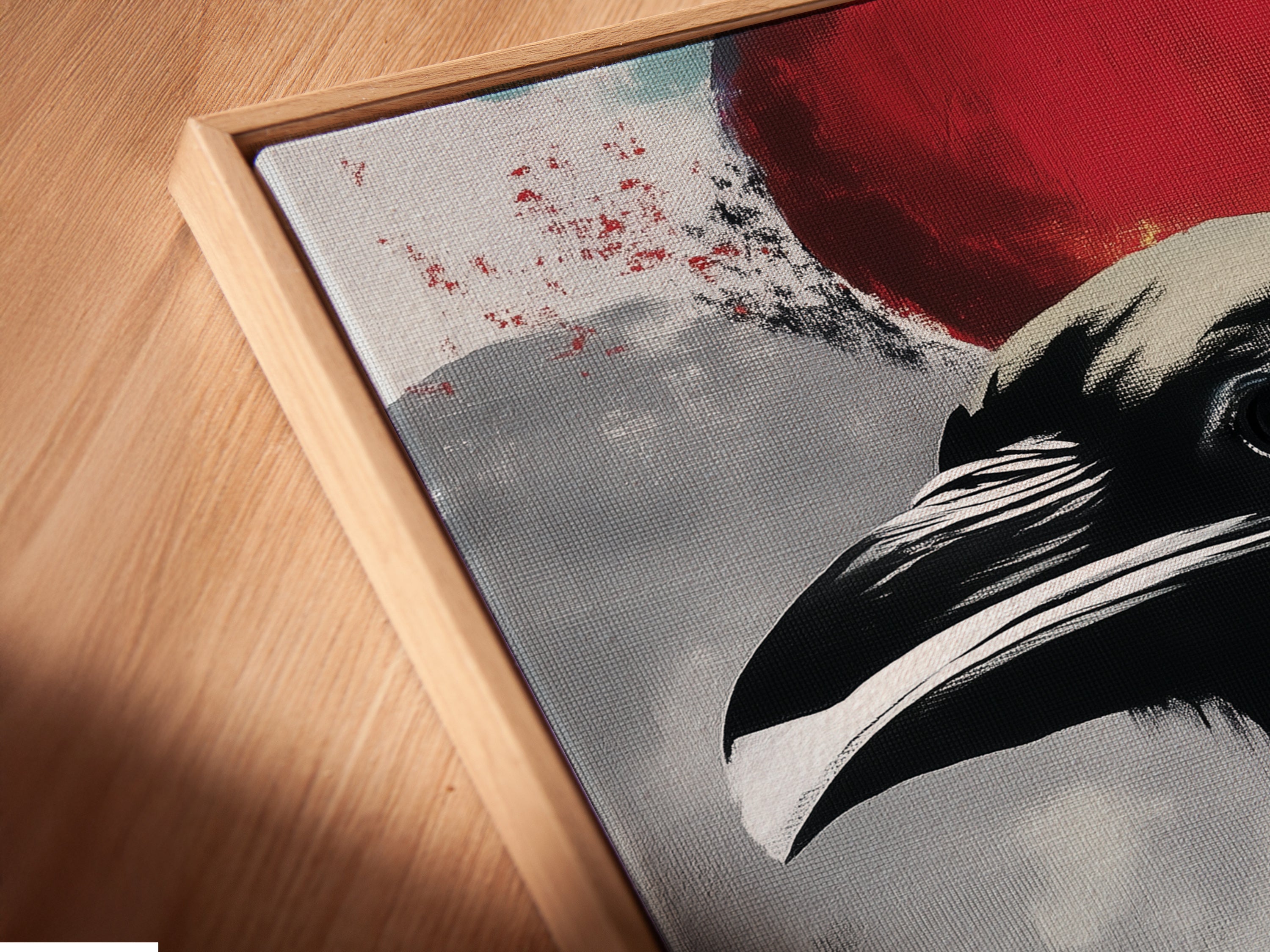 A close-up shows a canvas print of raven art in a floating frame. This modern gothic artwork offers a unique display. The colorful bird wall art enhances any room. Perfect for dark academia decor.