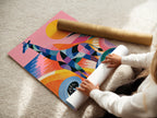A woman is carefully rolling a fine art poster paper. The paper is high-quality. It ensures the artwork looks its best. Fine art poster paper lets you frame the artwork yourself.