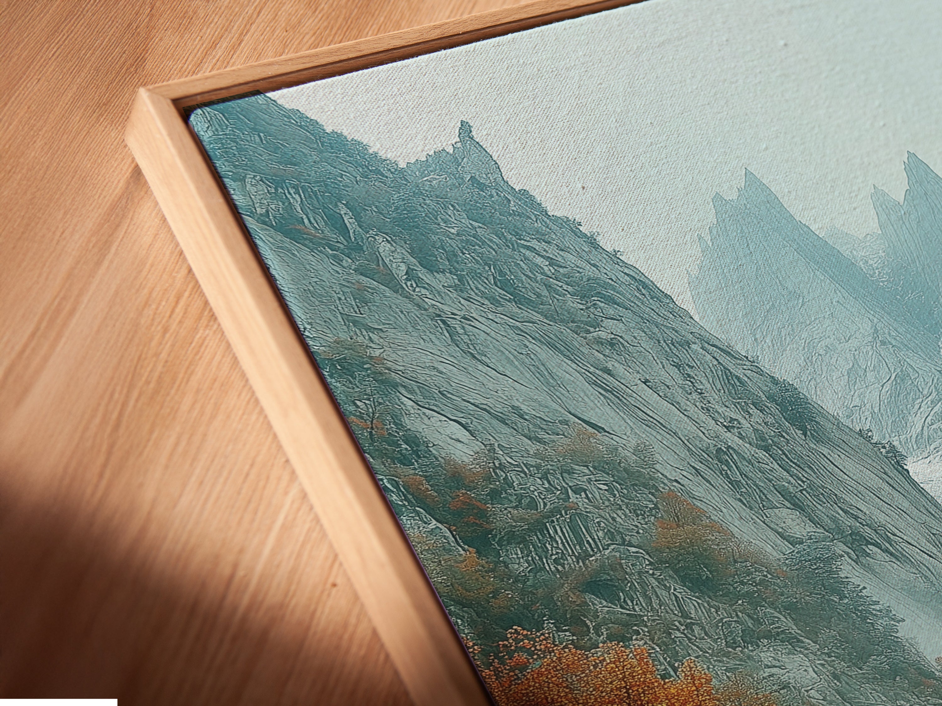 Close-up of a canvas print in a floating frame. The mountain valley artwork highlights the misty canyon and autumn landscape. This fine art piece adds a touch of sophistication to any wall. The floating frame enhances the canvas.