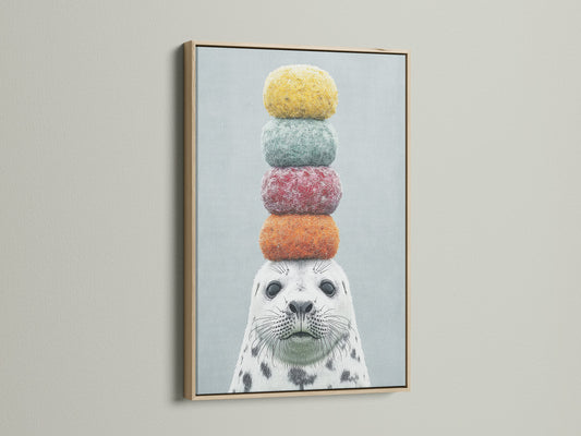 A close-up of a framed canvas print featuring a whimsical seal artwork. The art is framed in a natural oak frame. This colorful animal art adds a playful touch to any room. Ideal for kids rooms nurseries or anyone who loves marine life art.