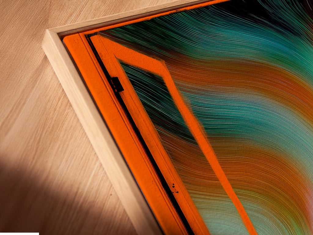 A close-up angled shot reveals a canvas print in a floating frame. Aurora Borealis artwork enhances this Nordic landscape wall art. The open window view brings teal and orange colors to life. Modern home art at its finest.