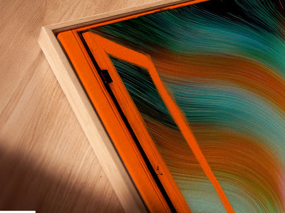 A close-up angled shot reveals a canvas print in a floating frame. Aurora Borealis artwork enhances this Nordic landscape wall art. The open window view brings teal and orange colors to life. Modern home art at its finest.