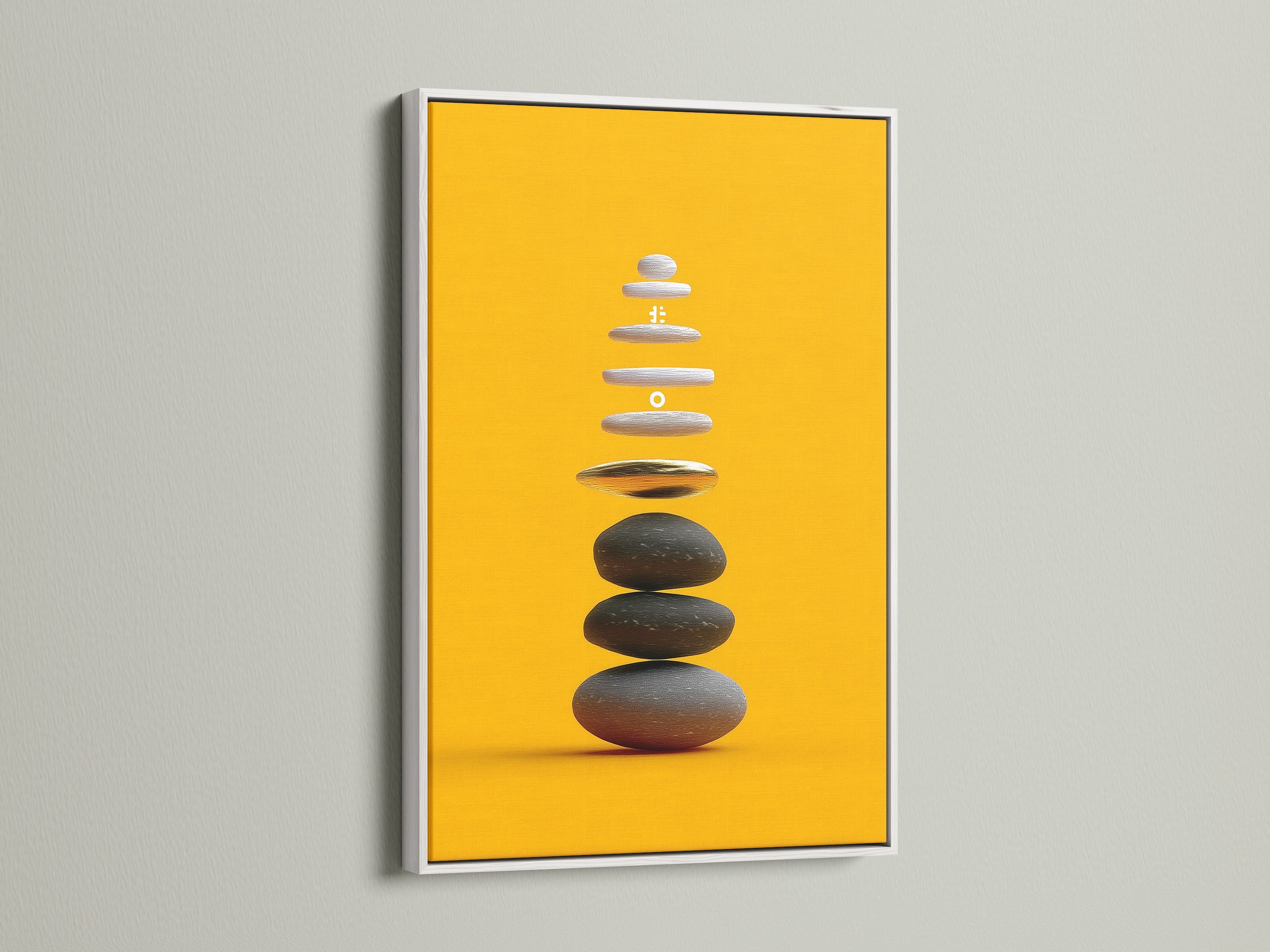 Zen Stone Canvas Print with a White Frame. This modern artwork enhances any room. The white frame complements the ochre yellow tones of the balancing stones art. A serene canvas for yoga studios.