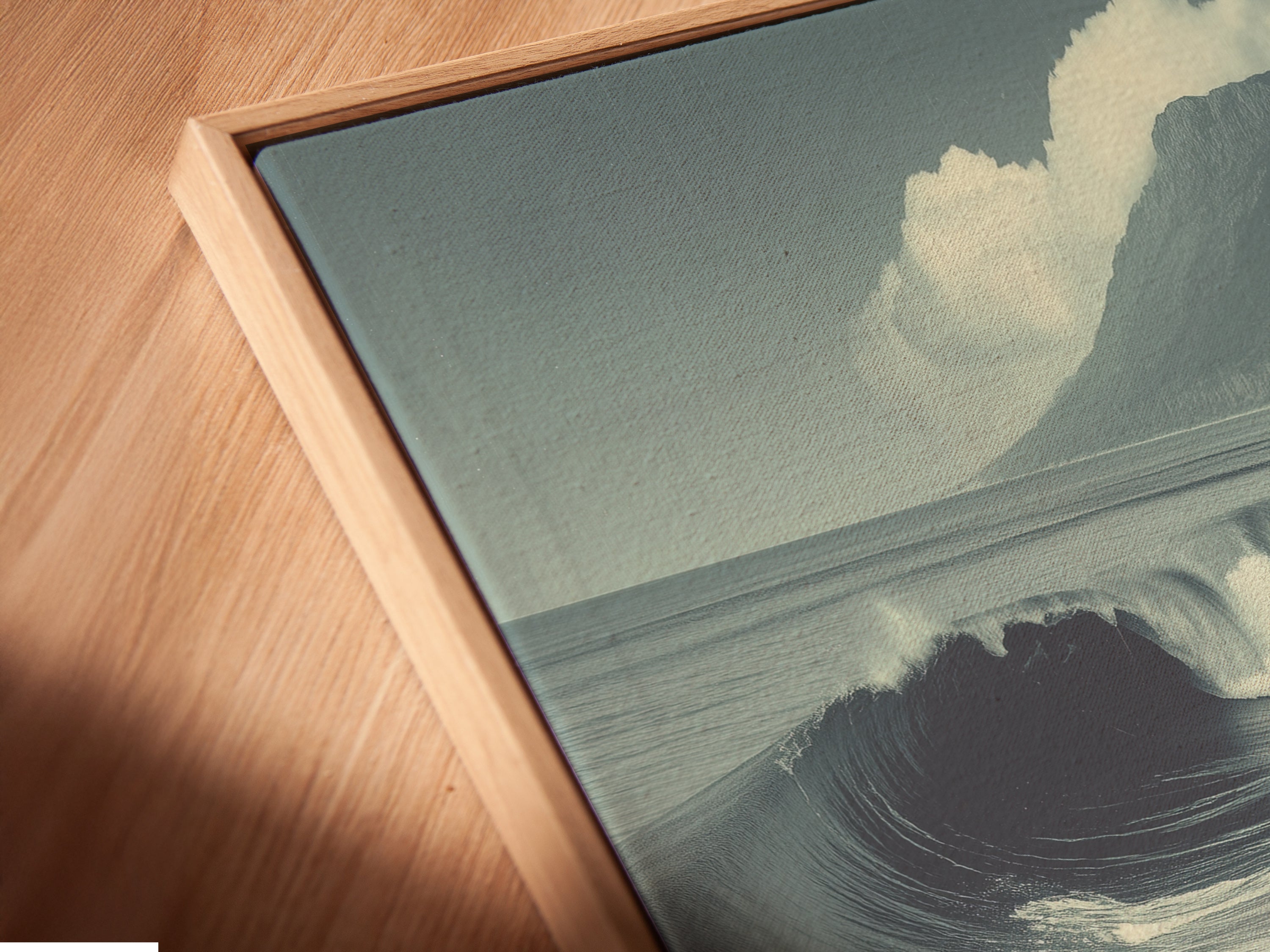 A close-up of a canvas print in a floating frame. The artwork appears to float within the frame. The floating frame provides a modern touch to any art. Perfect for displaying terracotta beach wall art.