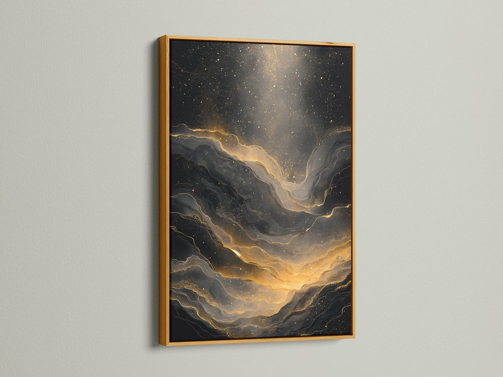 A gold frame showcases an abstract art piece. The art is black and gold. The gold frame adds a luxurious look to the artwork. It brings warmth and elegance to any space. The frame enhances the art. The gold accents complement the design.